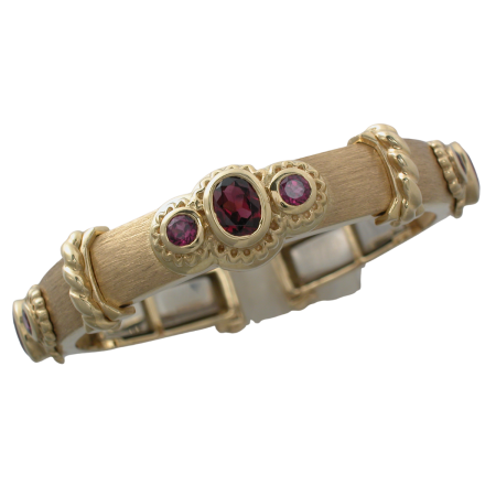 16444 Medium Width Rhodolite Garnet Callista Bangle Designed & Handmade by Kaufmann de Suisse in 18kt Yellow Gold featuring 9 Mixed Cut Rhodolite Garnets weighing a total of 7.86cts