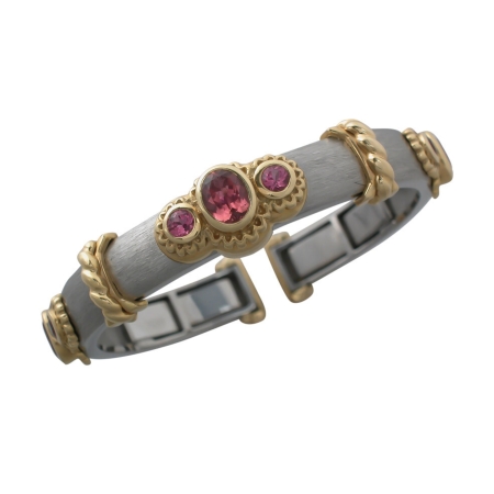 10500 Medium Wide Pink Tourmaline Callista Bangle Designed & Handmade by Kaufmann de Suisse in Stainless Steel and 18kt Yellow Gold featuring 9 Mixed cut Pink Tourmalines weighing a total of 5.13c