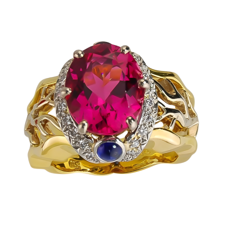 17161 Open Flowing Lines Pink Tourmaline Ring Designed & Handmade by Kaufmann de Suisse in 18kt Yellow Gold & Platinum featuring one Oval Pink Tourmaline weighing 4.69cts, 2 Round Cabochon Cut Blu
