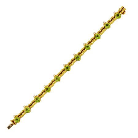 18942 Flowing Lines Peridot & Diamond Bracelet Designed & Handmade by Kaufmann de Suisse in 18kt Yellow Gold featuring 11 Cushion Cut Peridots weighing a total of 10.87cts and 11 Round Brilliant c