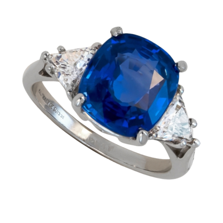 22882 Classic Three Stone Sapphire & Diamond Ring Designed and Handmade by Kaufmann de Suisse in Platinum featuring one Cushion Cut 4.87cts Blue Sapphire flanked by two HVS Quality Triangle Diamon