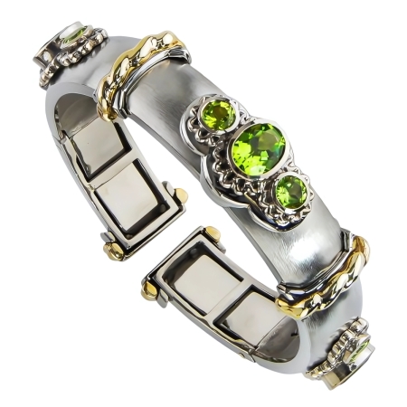 40417A Wide Peridot Callista Bangle Designed & Handmade by Kaufmann de Suisse in 18kt White Gold featuring 3 Oval Peridots weighing a total of 5.88cts and 6 Round Peridots weighing a totla of 4.00
