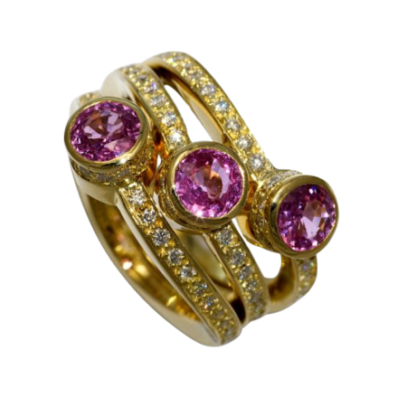 30503 A triple gold band wraps around 137 diamonds and extends its reach to three beautiful pink sapphires, the color of blushing coral. The elegant Queen’s Coral ring is a lavish accessory that’s
