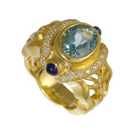 21301 Double Flowing Lines Oval Blue Topaz Ring Designed & Handmade by Kaufmann de Suisse in 18kt Yellow Gold featuring a 3.09cts Oval cut Blue Topaz