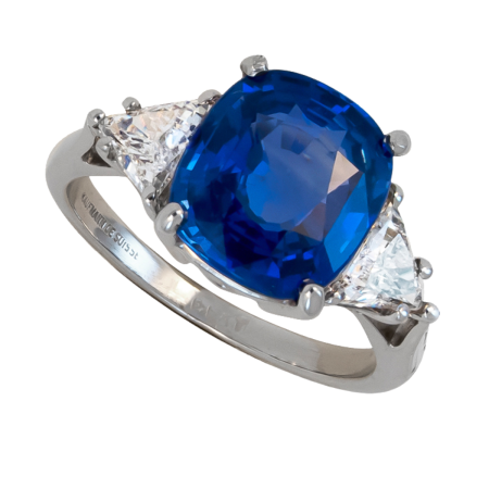 22882 Classic Three Stone Sapphire & Diamond Ring Designed and Handmade by Kaufmann de Suisse in Platinum featuring one Cushion Cut 4.87cts Blue Sapphire flanked by two HVS Quality Triangle Diamon