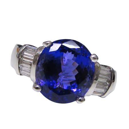 23688 Classic Tanzanite and Diamond Ring Designed & Handmade by Kaufmann de Suisse in 18kt White Gold featuring 1 Oval Tanzanite weighing 6.44cts flanked by 12 Baguette HVS Quality Diamonds weighi