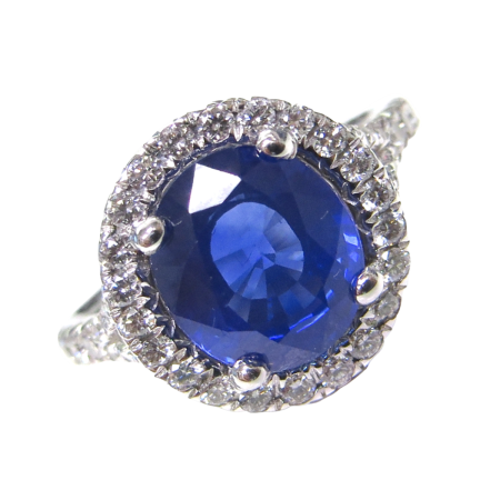 23916 Sapphire and Diamond Halo Ring Designed and Handmade in 18kt White Gold featuring one Oval 3.15cts Blue Sapphire surrounded by 46 Round Brilliant cut GVS Quality Diamonds