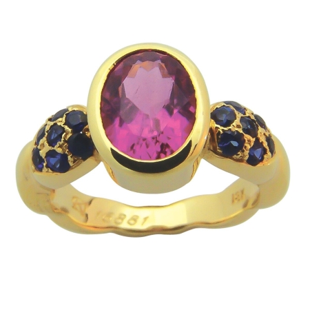16881 Single Flowing Lines Pink Tourmaline & Blue Sapphire Ring featuring 1 Oval Pink Tourmaline weighing 1.88cts mounted with 14 Round Blue Sapphires weighing 0.53cts.