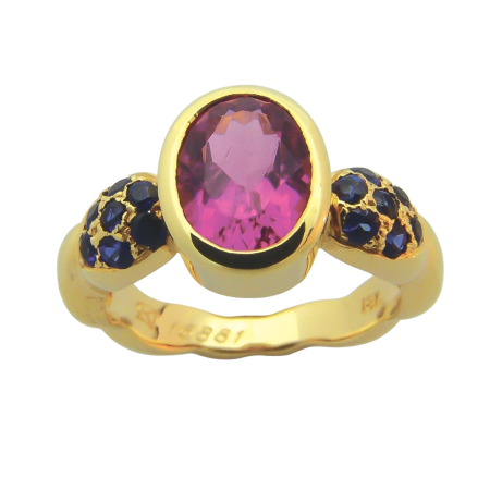 16881 Single Flowing Lines Pink Tourmaline & Blue Sapphire Ring featuring 1 Oval Pink Tourmaline weighing 1.88cts mounted with 14 Round Blue Sapphires weighing 0.53cts.