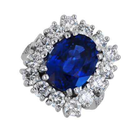 24310 Important Sapphire and Diamond Ring Designed & Handmade in Platinum by Kaufmann de Suisse featuring one 12.17 cts AGL Certified No Heat Cushion Cut Ceylon Sapphire surrounded by 14 Round Bri